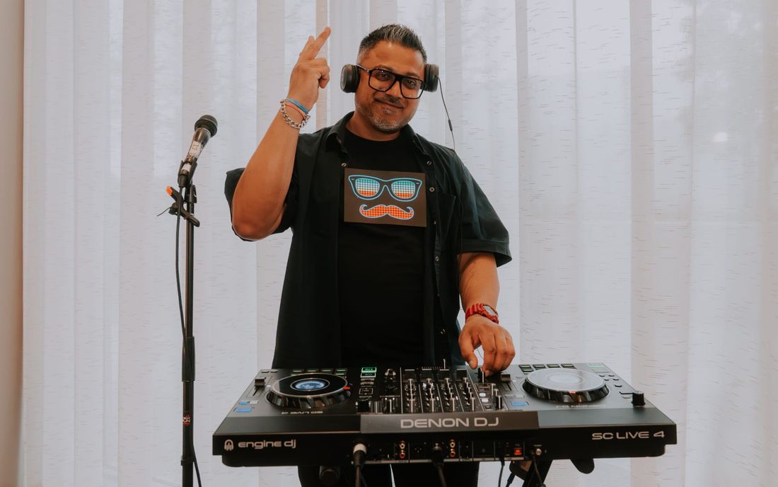 DJ performing with a Denon controller setup