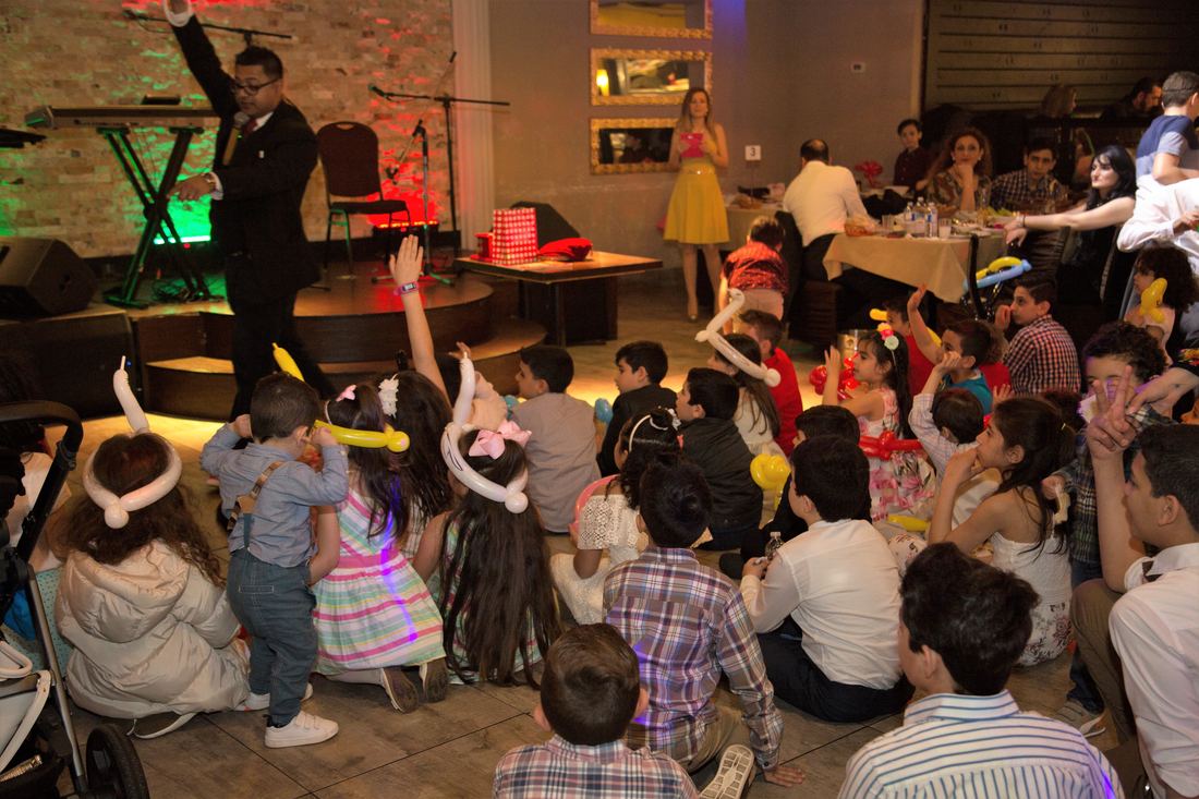 Seated audience watching a parlor magic show